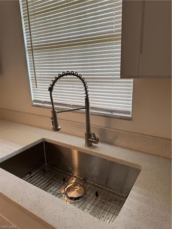 a kitchen with a sink and a window
