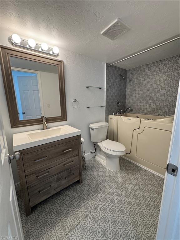 3325 Airport-Pulling Road North, Unit E4 Naples, FL 34105 - Photo 10 of 11 a bathroom with a toilet a sink and mirror