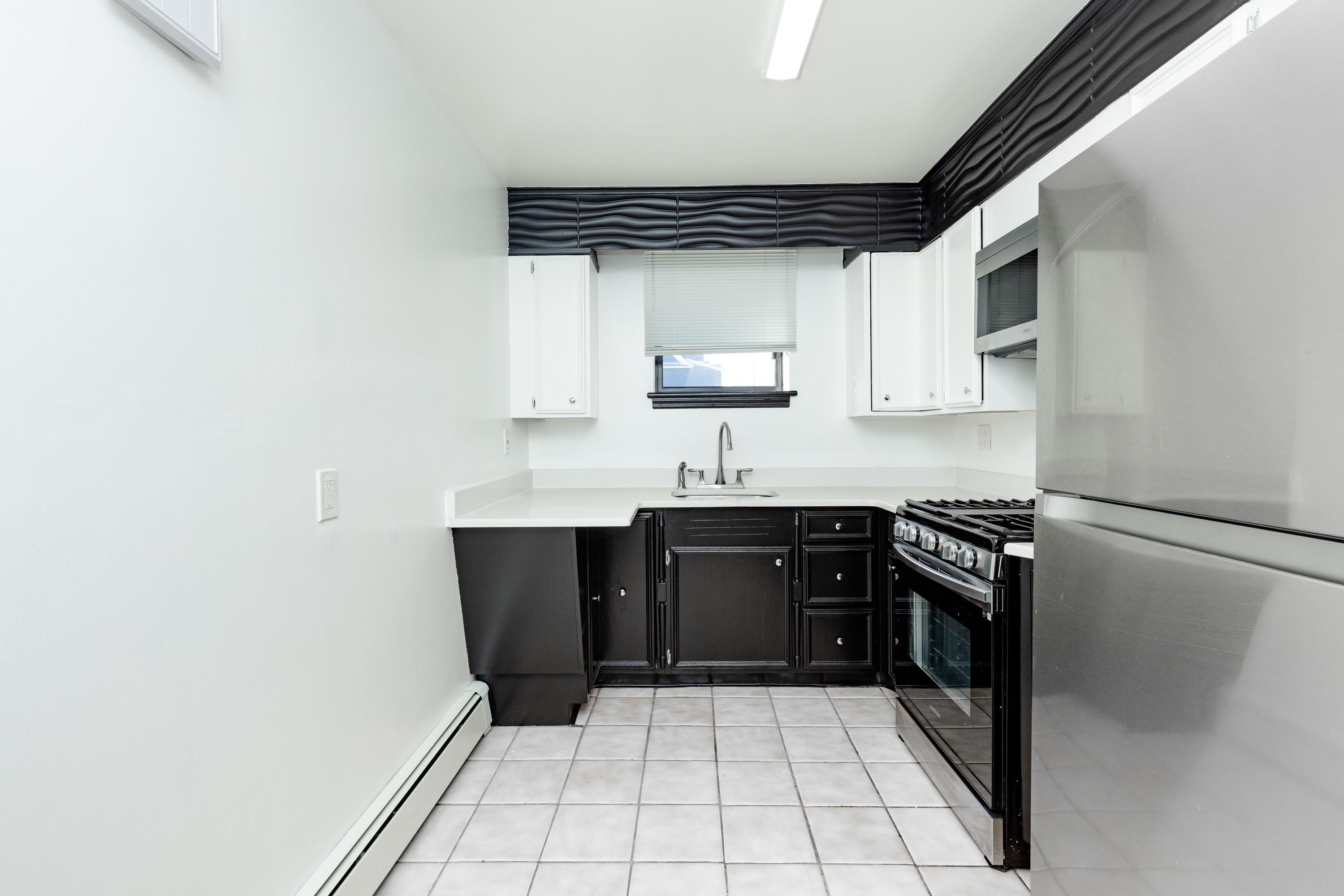 100 Lakeview Avenue, Unit 2A Clifton, NJ 07011 - Photo 11 of 13 a kitchen with a sink a stove and refrigerator