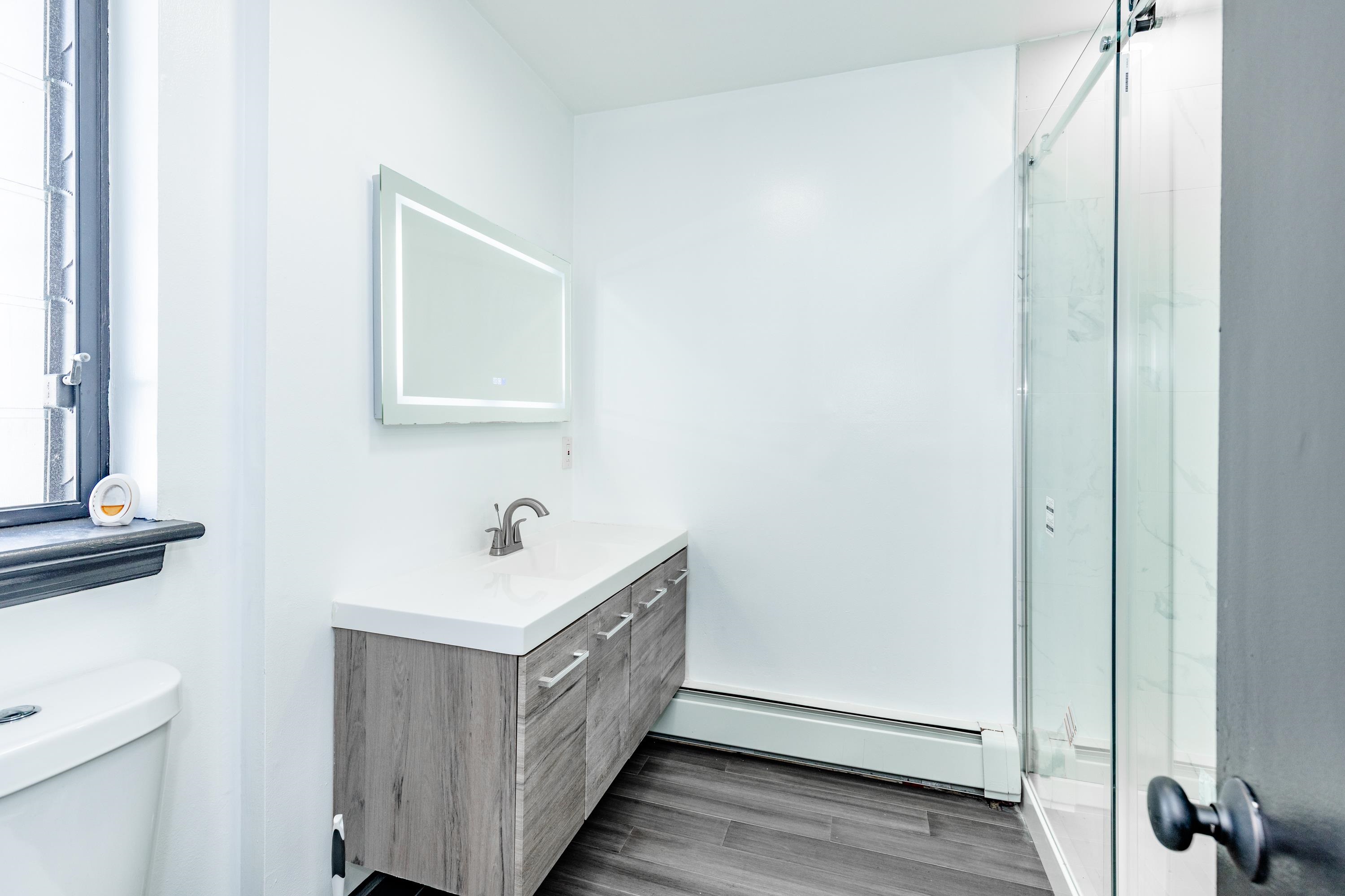 100 Lakeview Avenue, Unit 2A Clifton, NJ 07011 - Photo 13 of 13 a bathroom with a sink a toilet and a mirror