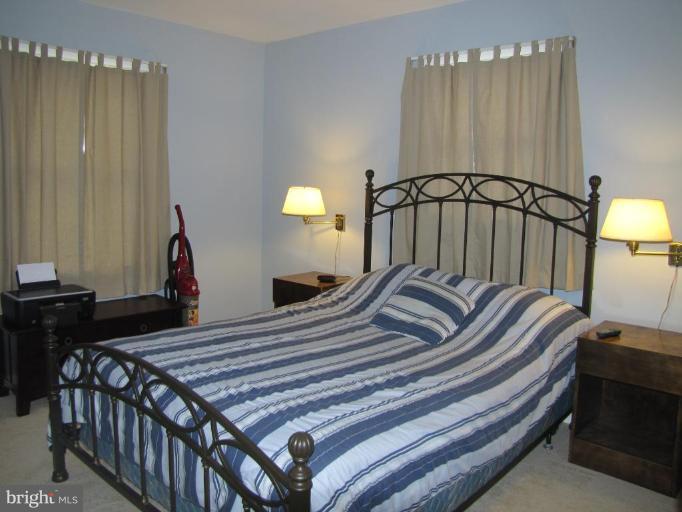 13046 Independence Road Clear Spring, MD 21722 - Photo 12 of 26 a bedroom with a bed and a chandelier