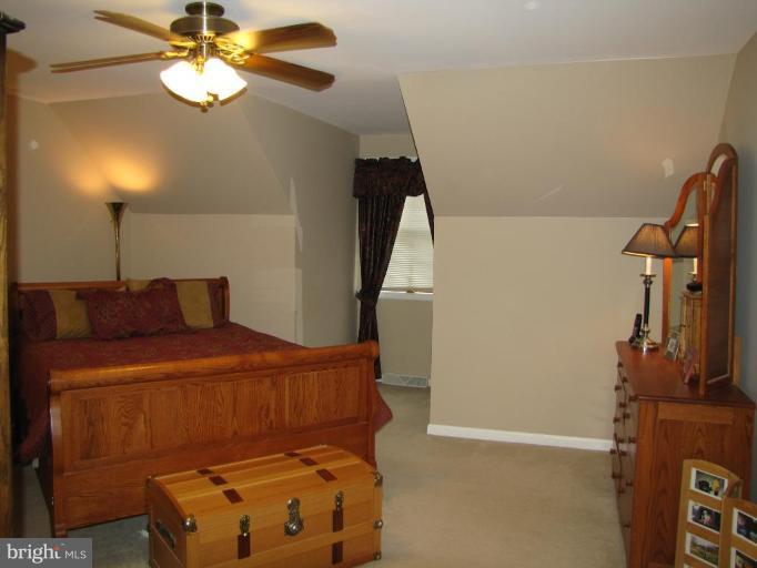 13046 Independence Road Clear Spring, MD 21722 - Photo 14 of 26 a bedroom with a bed and a chandelier