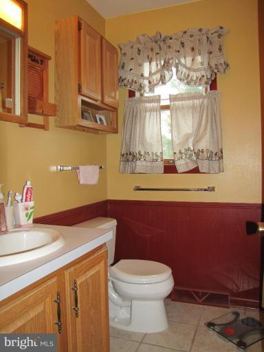 13046 Independence Road Clear Spring, MD 21722 - Photo 15 of 26 a bathroom with a sink a toilet and mirror