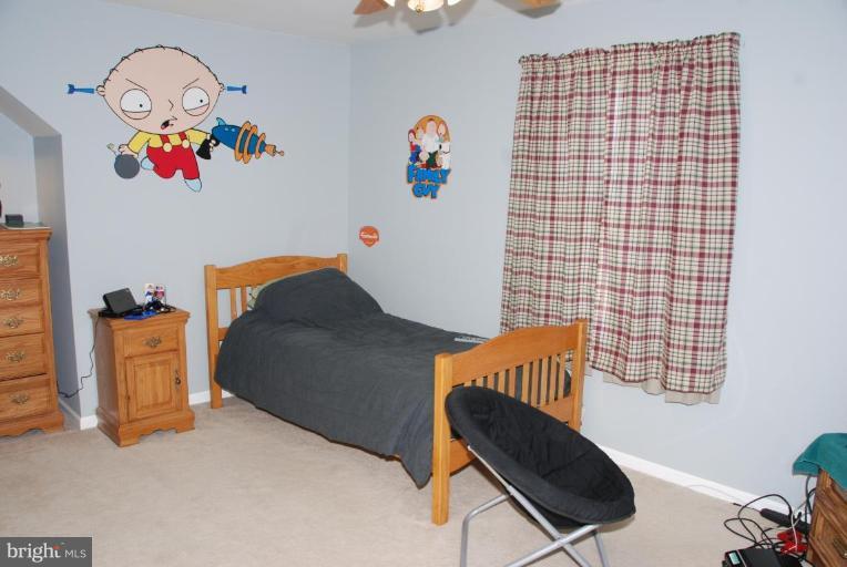 13046 Independence Road Clear Spring, MD 21722 - Photo 21 of 26 a blue bed sitting in a bedroom next to a window