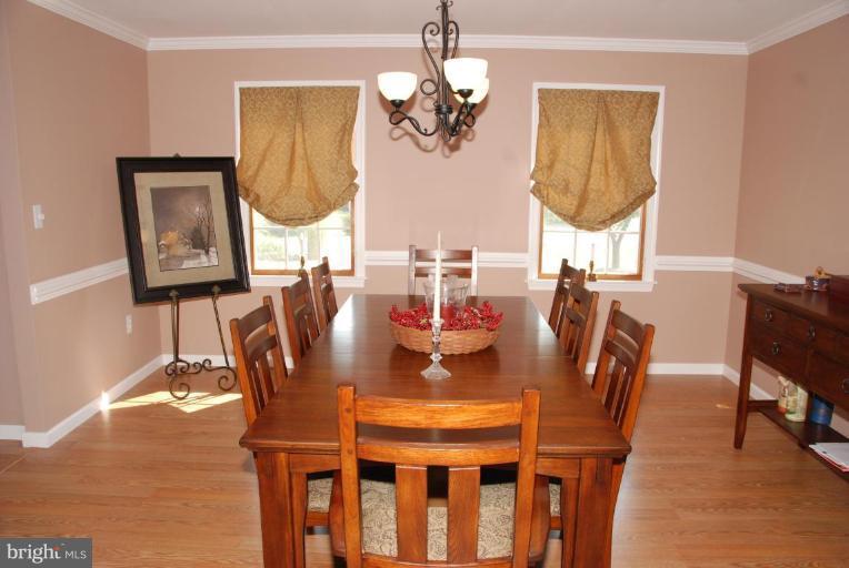 13046 Independence Road Clear Spring, MD 21722 - Photo 7 of 26 a dining room with chandelier and wooden floor