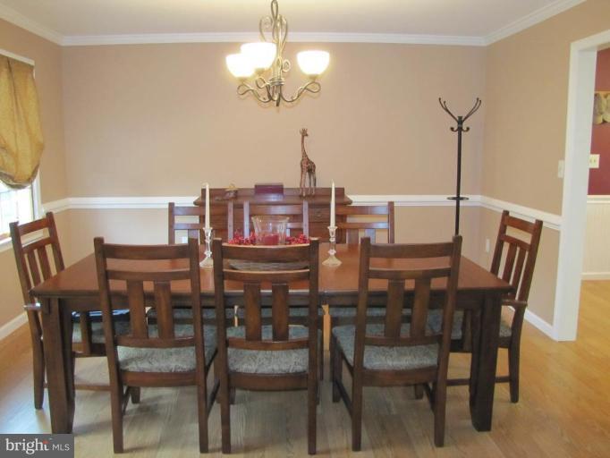 13046 Independence Road Clear Spring, MD 21722 - Photo 8 of 26 a view of a dining room with furniture a chandelier and wooden floor