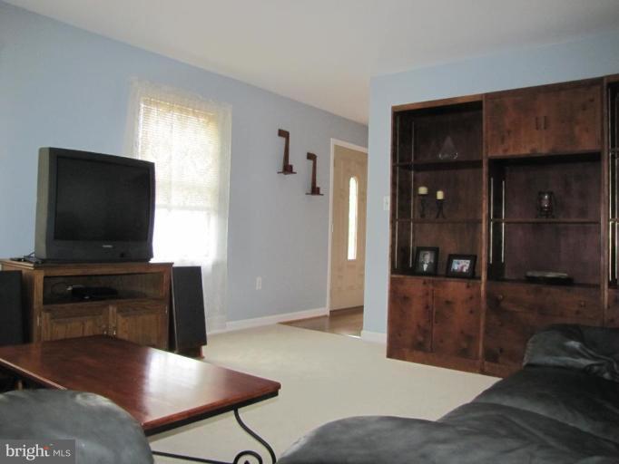 13046 Independence Road Clear Spring, MD 21722 - Photo 9 of 26 a living room with furniture and a flat screen tv