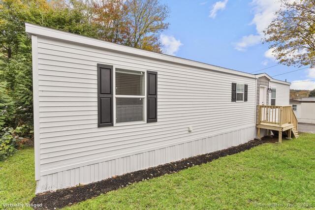 55 Sugar Street, Unit 27 Newtown, CT 06470 - Photo 15 of 17 a front view of a house with a yard