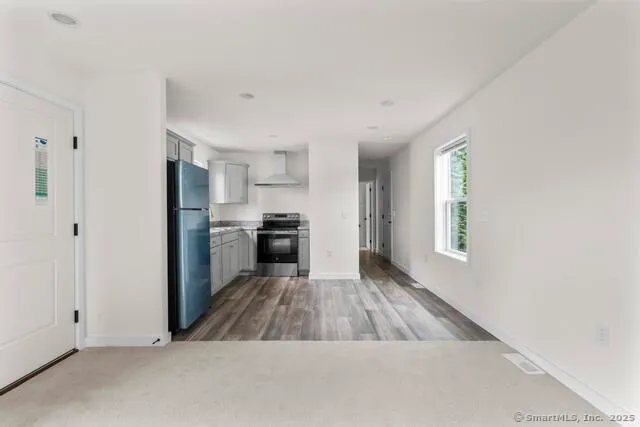 a kitchen with a refrigerator a stove top oven and kitchen island