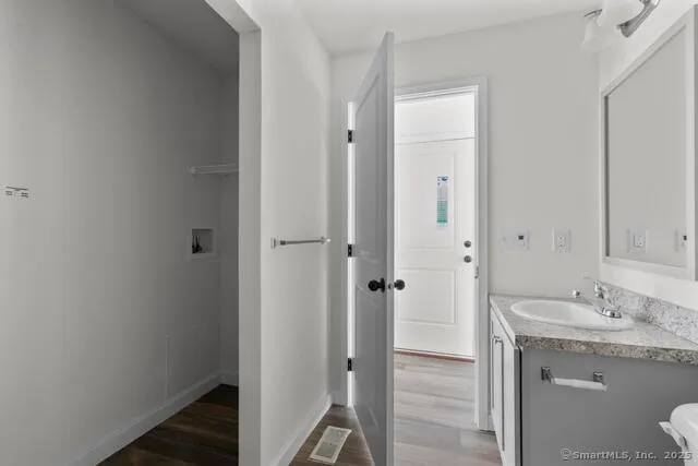a bathroom with a granite countertop sink and a mirror