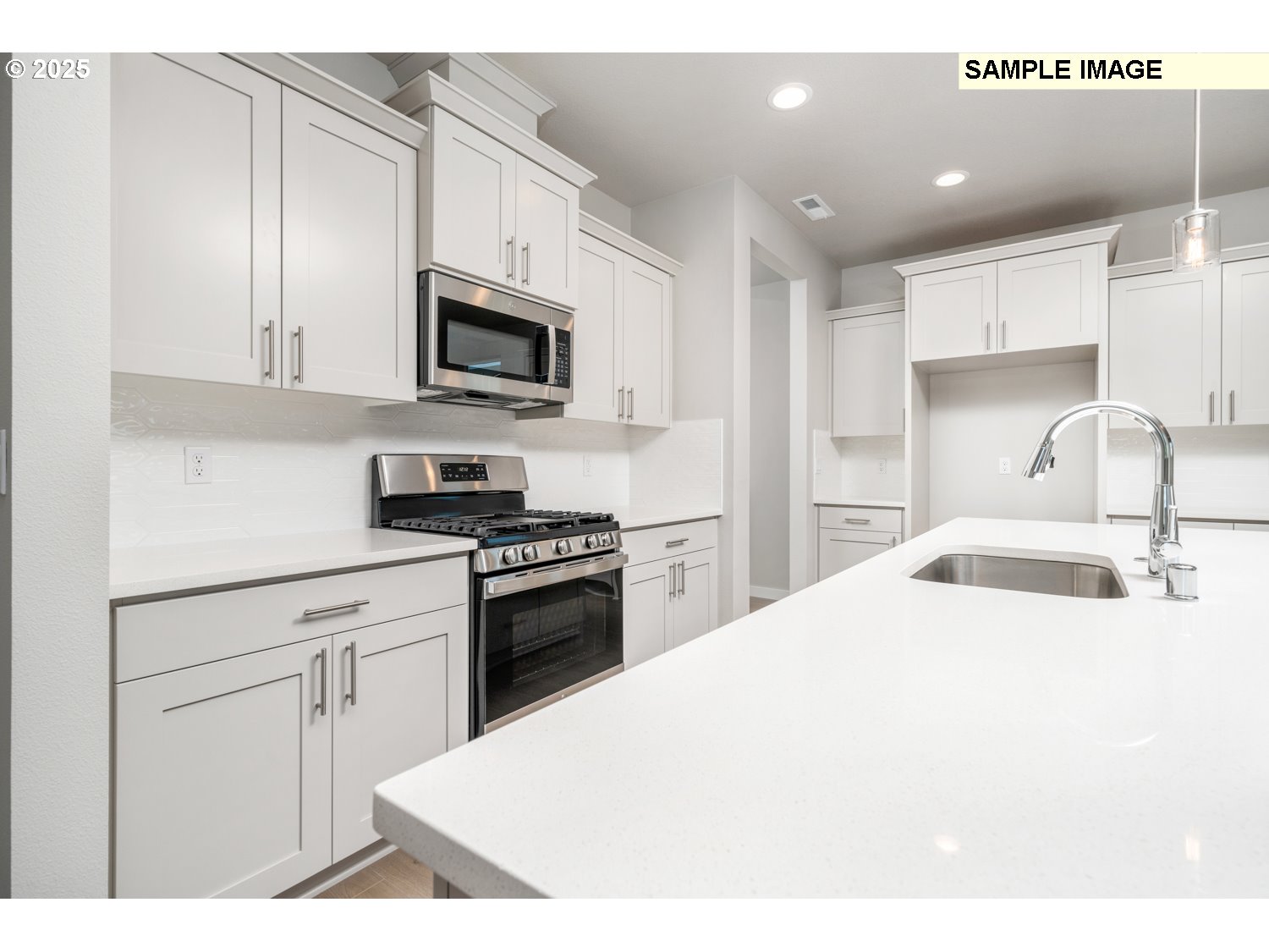 8822 South 1st Street, Unit 15 Ridgefield, WA 98642 - Photo 9 of 21 a kitchen with stainless steel appliances a sink a stove a microwave and cabinets