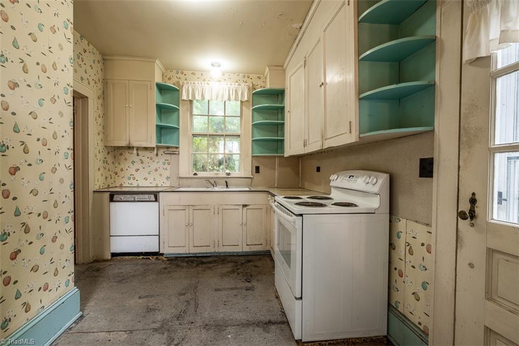 124 Hawthorne Road Elkin, NC 28621 - Photo 16 of 42 Cozy den with wood paneled walls, fireplace and door leading to kitchen.