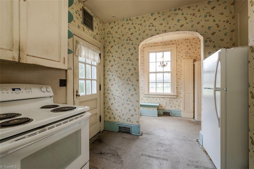 124 Hawthorne Road Elkin, NC 28621 - Photo 17 of 42 Den with bank of windows overlooking back yard and doorway leading to foyer and staircase to second level.