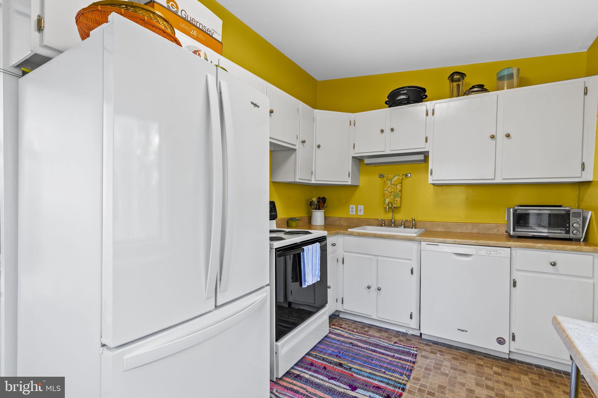 1928 Elm Road Port Republic, MD 20676 - Photo 17 of 48 a kitchen with a sink a stove and cabinets