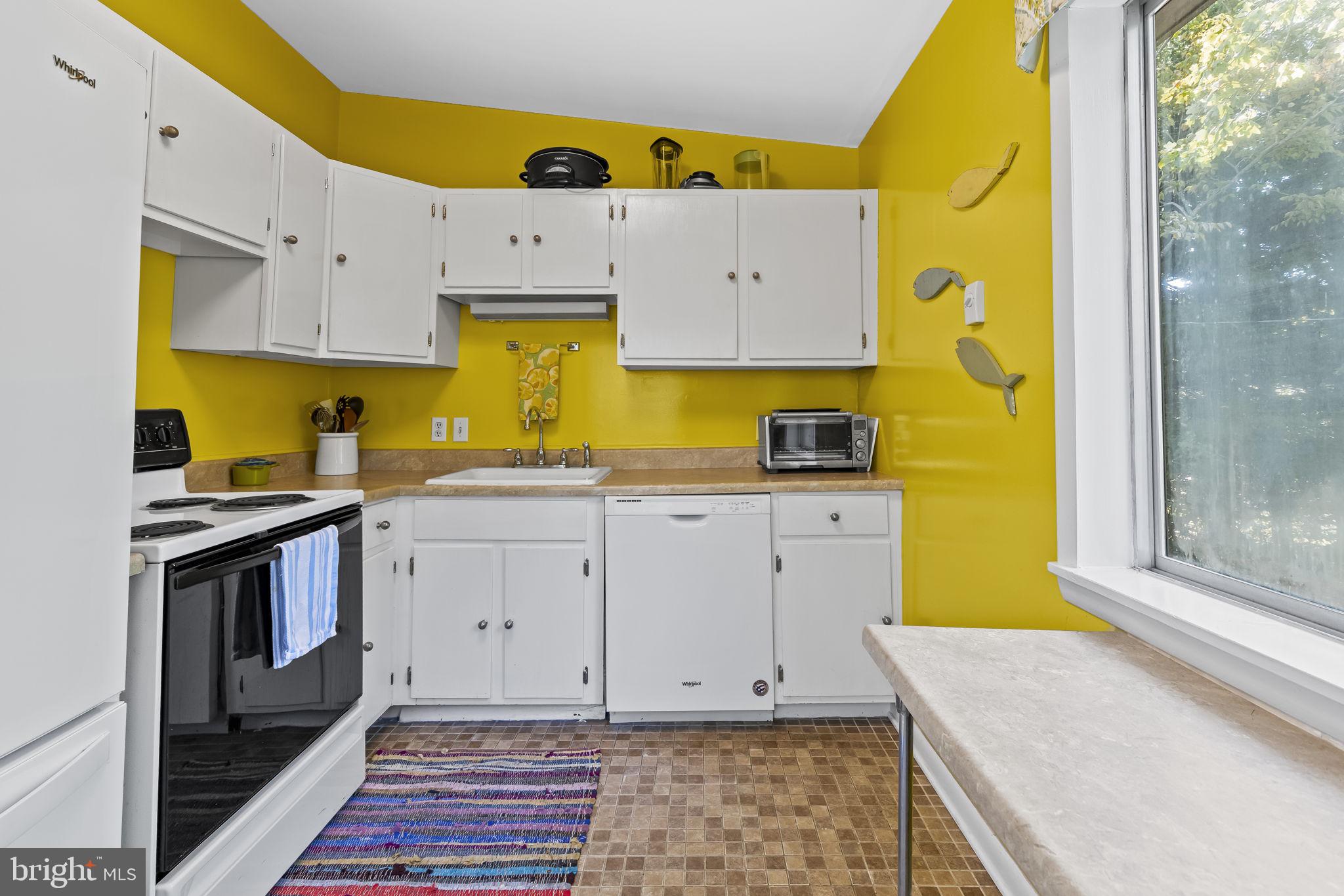 1928 Elm Road Port Republic, MD 20676 - Photo 18 of 48 a kitchen with a sink a stove and cabinets