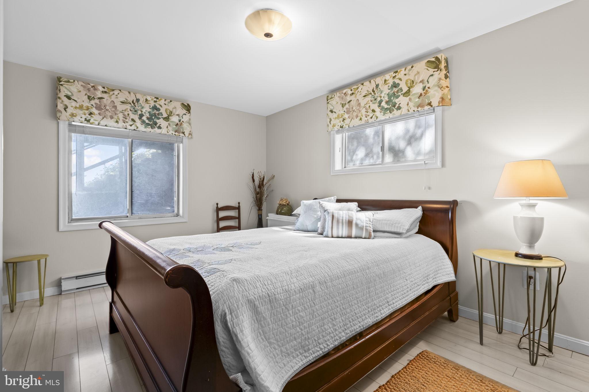 1928 Elm Road Port Republic, MD 20676 - Photo 21 of 48 a bedroom with a bed and a chandelier