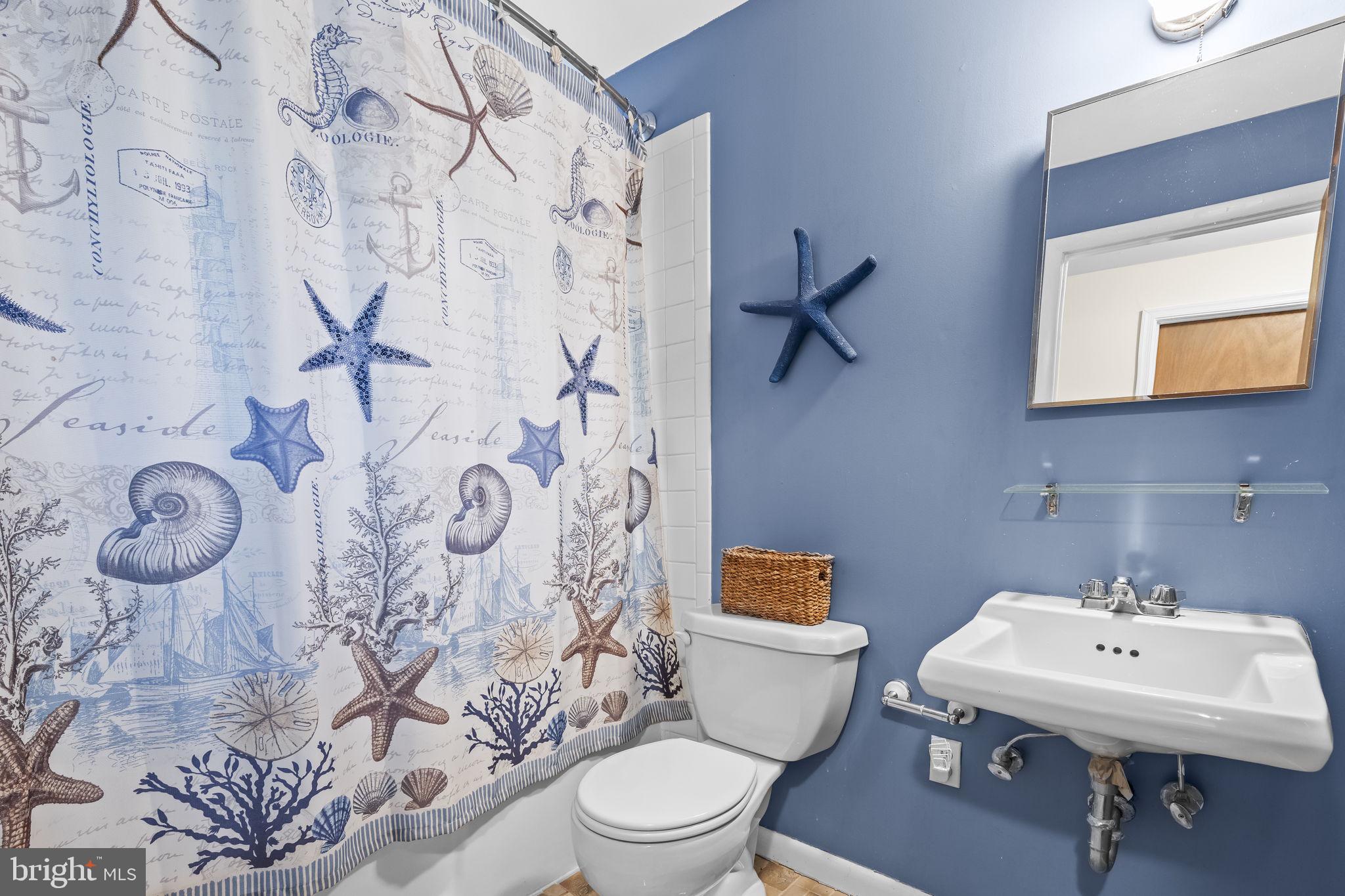 1928 Elm Road Port Republic, MD 20676 - Photo 27 of 48 a bathroom with a toilet sink and mirror