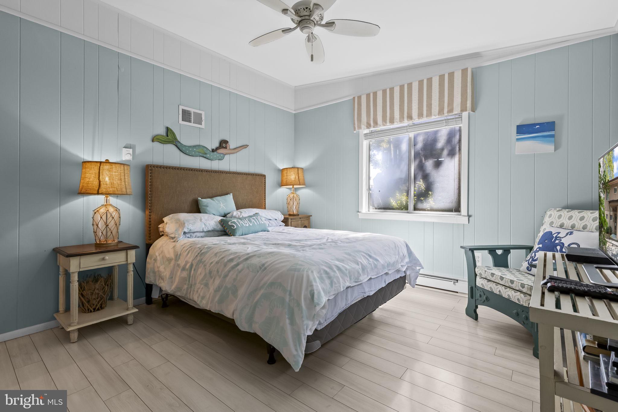 1928 Elm Road Port Republic, MD 20676 - Photo 30 of 48 a bedroom with a bed and a chandelier