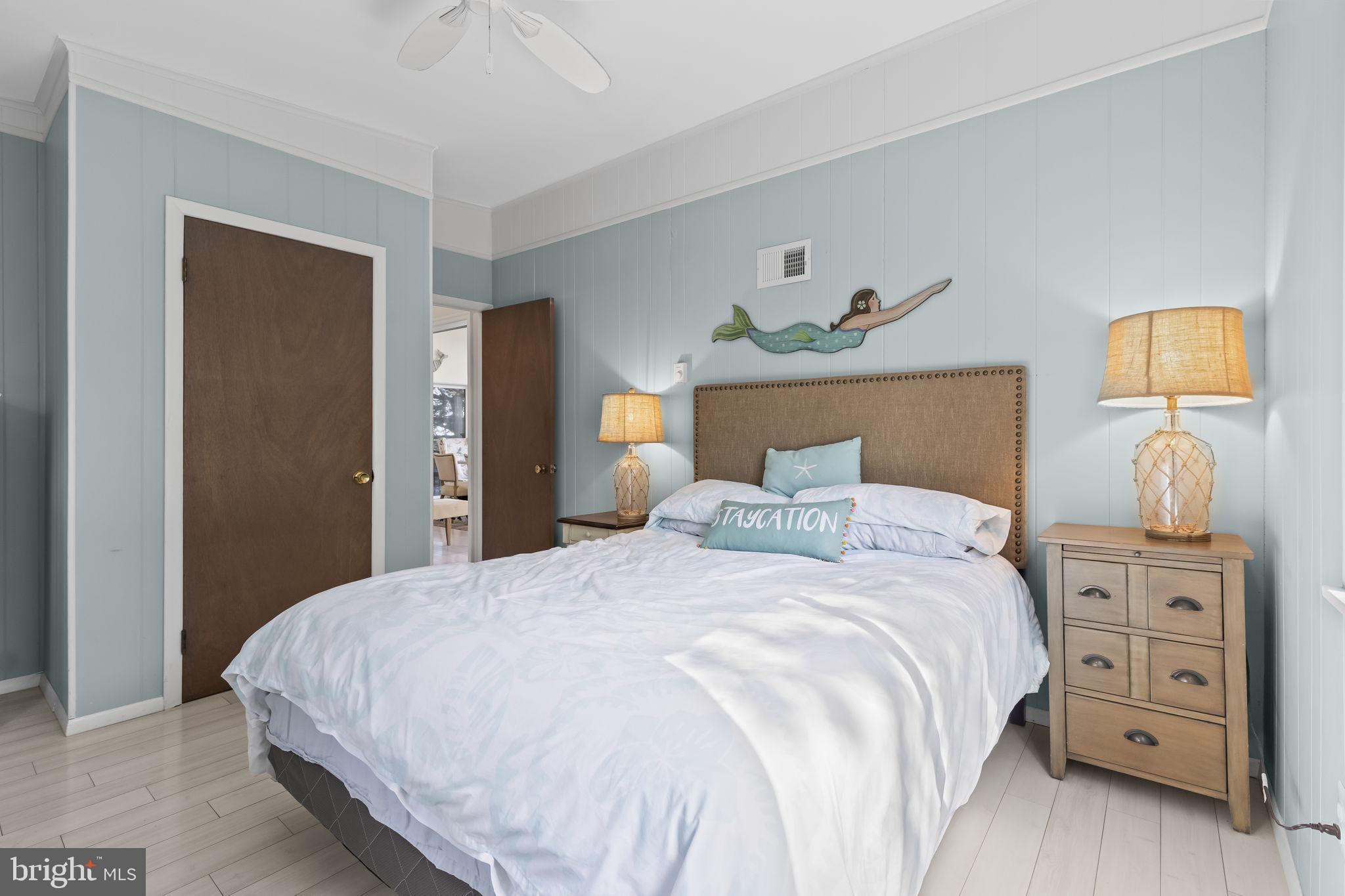 1928 Elm Road Port Republic, MD 20676 - Photo 31 of 48 a bedroom with a bed and a lamp on dresser