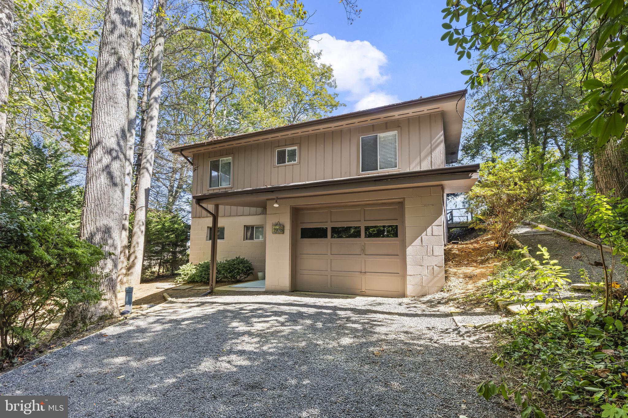 1928 Elm Road Port Republic, MD 20676 - Photo 4 of 48 a front view of a house with a yard and garage