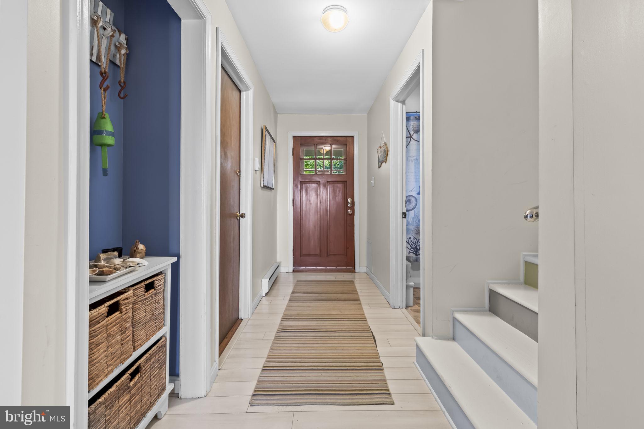 1928 Elm Road Port Republic, MD 20676 - Photo 8 of 48 a view of a hallway with wooden floor and a bathroom