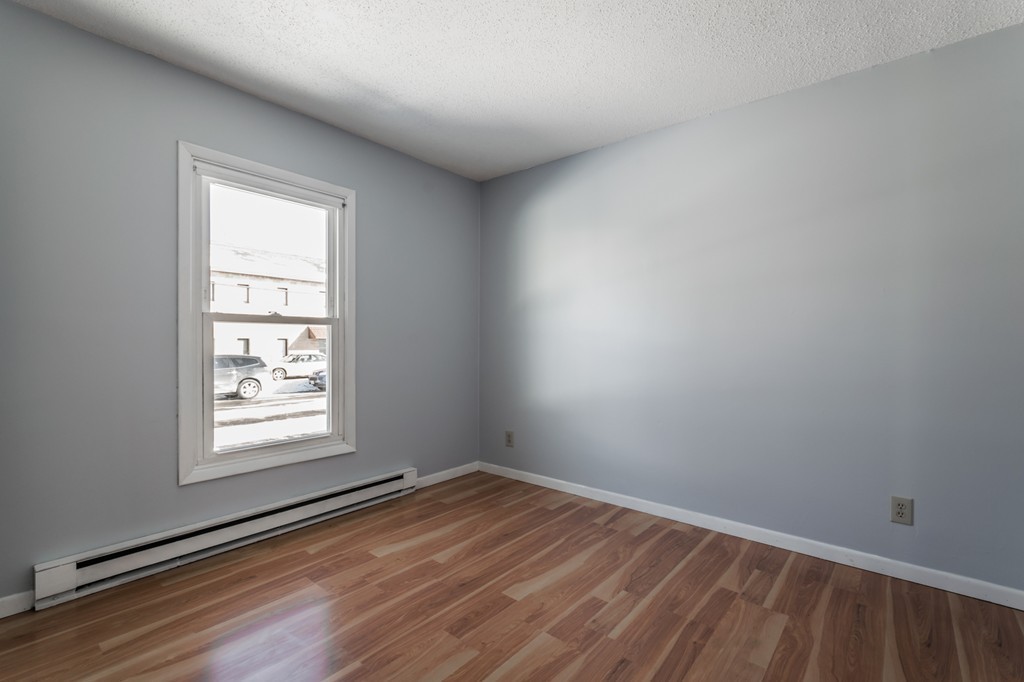 16 Prentice Street Springfield, MA 01104 - Photo 14 of 17 wooden floor in an empty room with a window