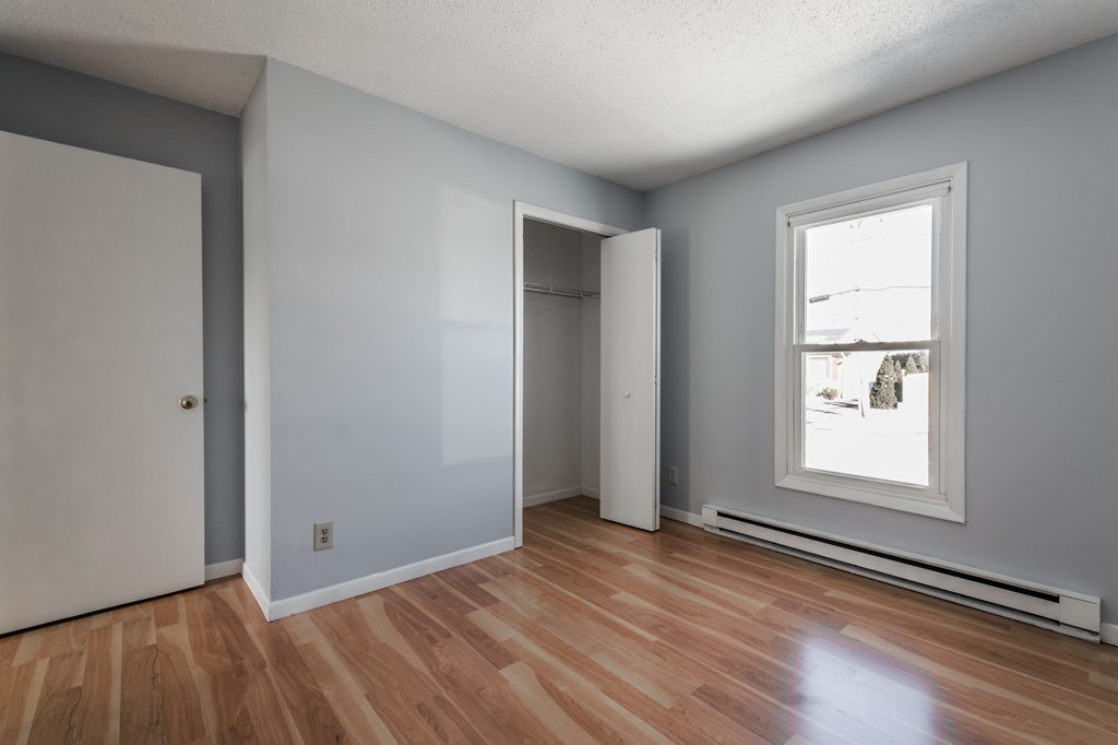 16 Prentice Street Springfield, MA 01104 - Photo 15 of 17 an empty room with wooden floor and windows