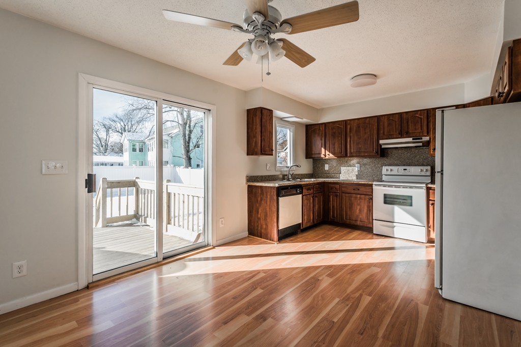 16 Prentice Street Springfield, MA 01104 - Photo 2 of 17 a kitchen with stainless steel appliances granite countertop a stove top oven a refrigerator and a sink with wooden floor