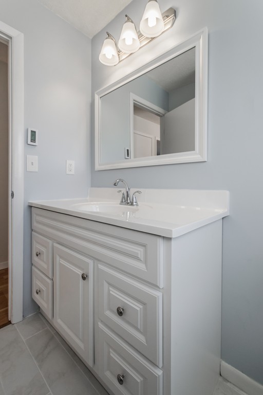 16 Prentice Street Springfield, MA 01104 - Photo 7 of 17 a bathroom with a sink vanity and mirror