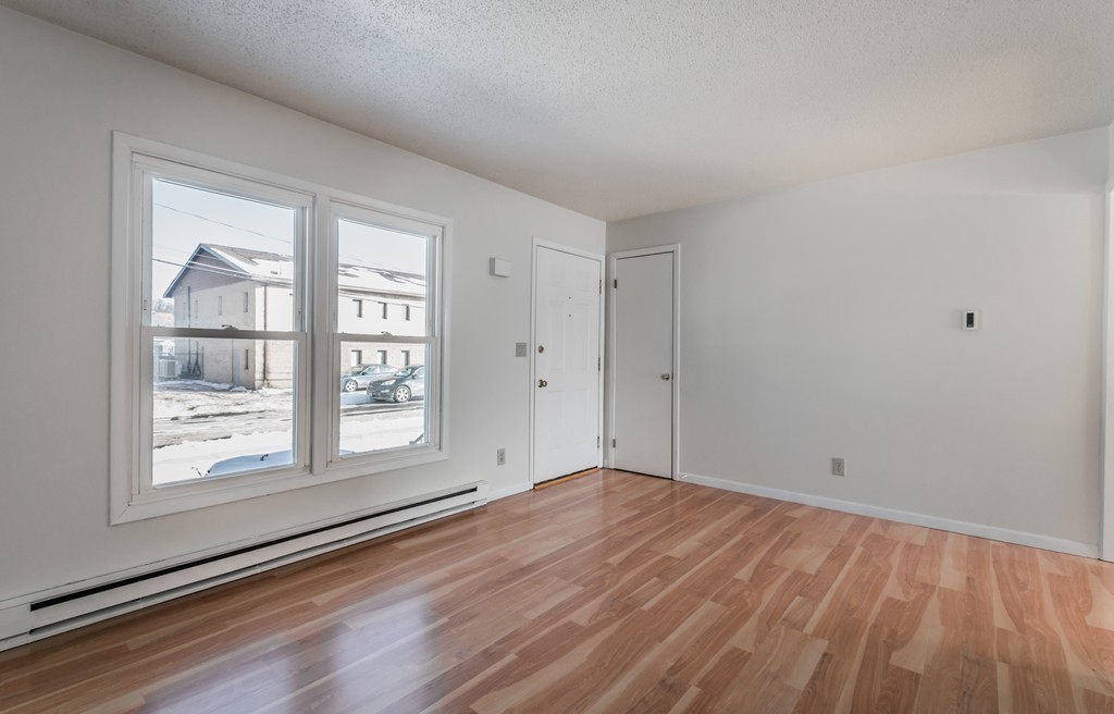 16 Prentice Street Springfield, MA 01104 - Photo 8 of 17 a view of an empty room with wooden floor and a window