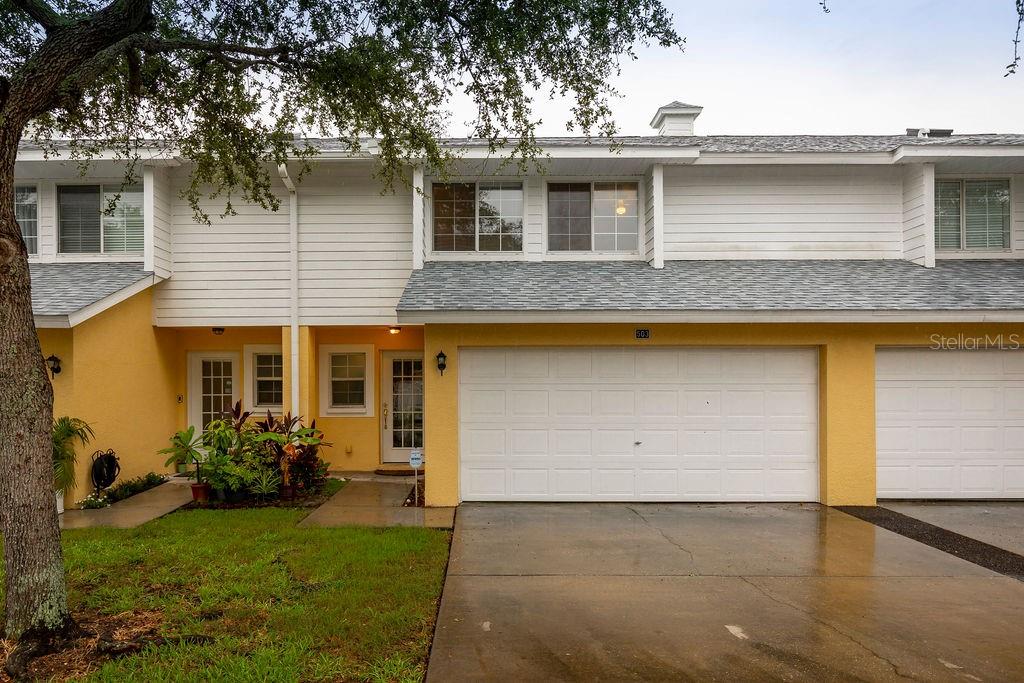 1132 Sunset Point Road, Unit 503 Clearwater, FL 33755 - Photo 1 of 1 a front view of a house with garden
