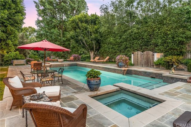 a patio with a table and chairs under an umbrella