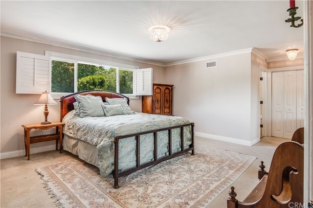 a bedroom with a bed and a chair