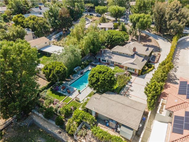 an aerial view of a house with a yard and garden