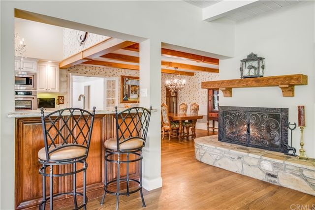 a living room with furniture a fireplace and a large window