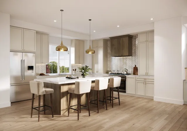 a kitchen with a dining table chairs refrigerator and cabinets