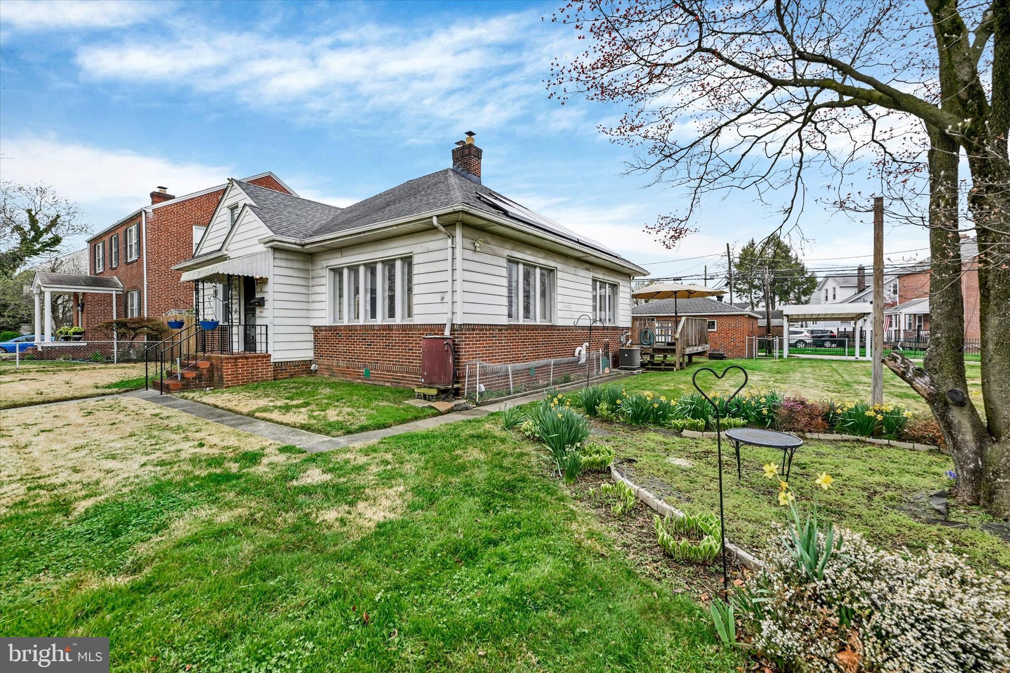 5 Liberty Parkway Baltimore, MD 21222 - Photo 2 of 31 a front view of a house with a yard and potted plants