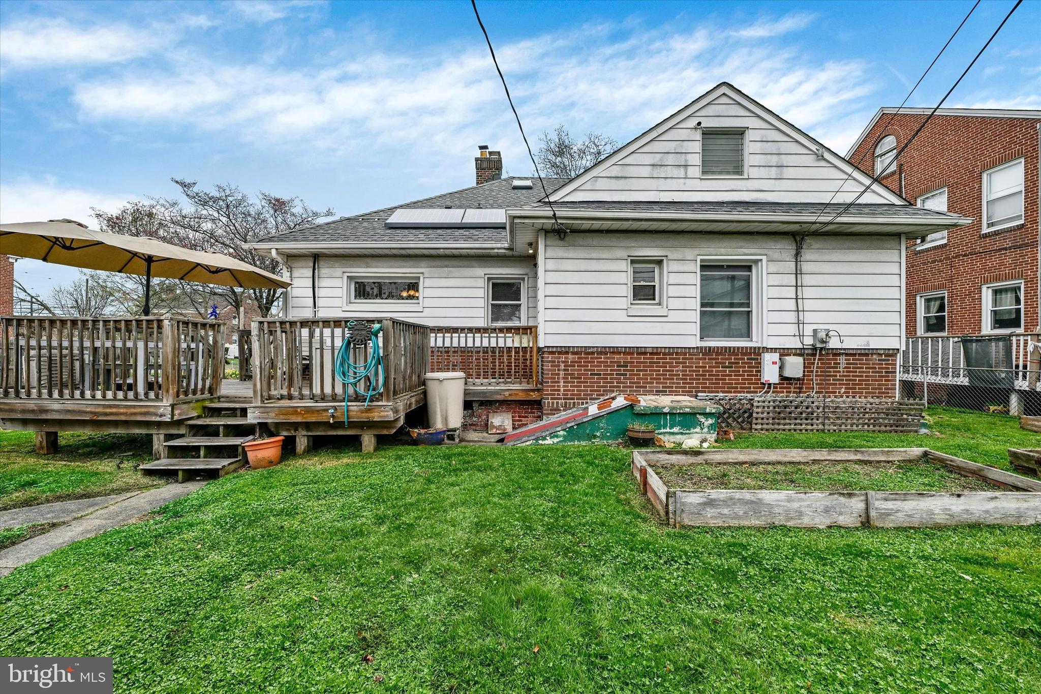 5 Liberty Parkway Baltimore, MD 21222 - Photo 25 of 31 a front view of a house with a garden and deck