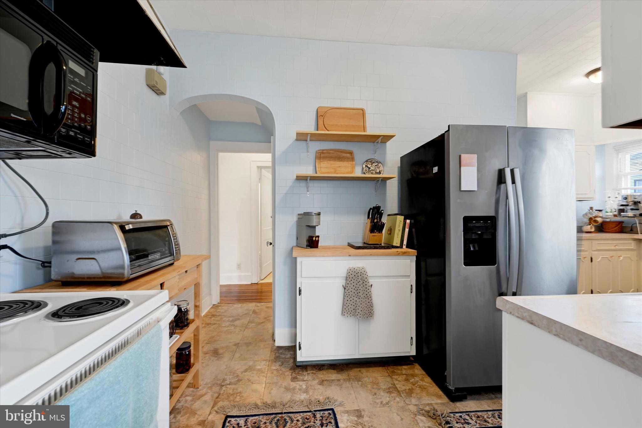 5 Liberty Parkway Baltimore, MD 21222 - Photo 4 of 31 a kitchen with a sink a refrigerator a stove top oven a counter space and wooden floor