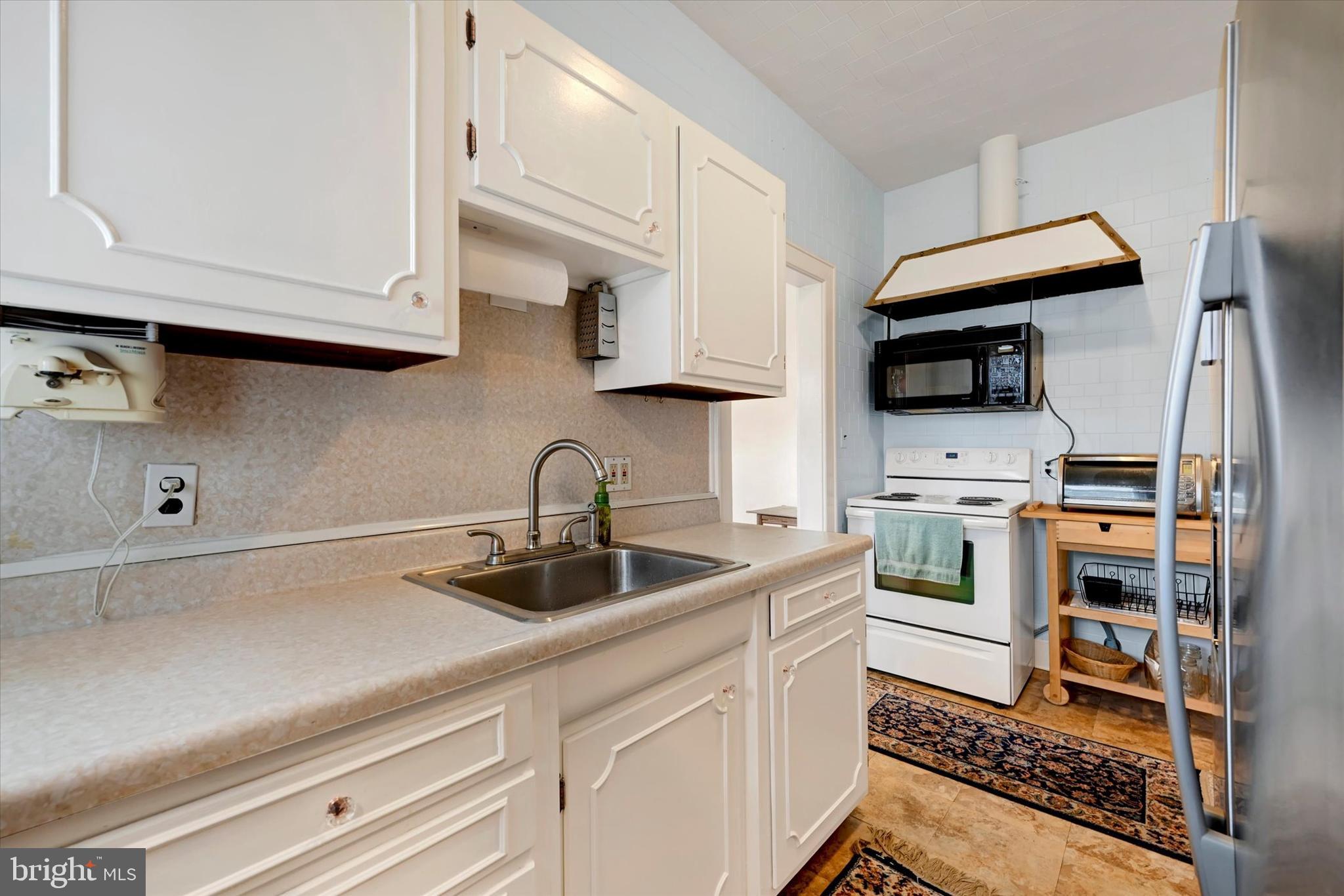 5 Liberty Parkway Baltimore, MD 21222 - Photo 5 of 31 a kitchen with stainless steel appliances a sink stove and cabinets