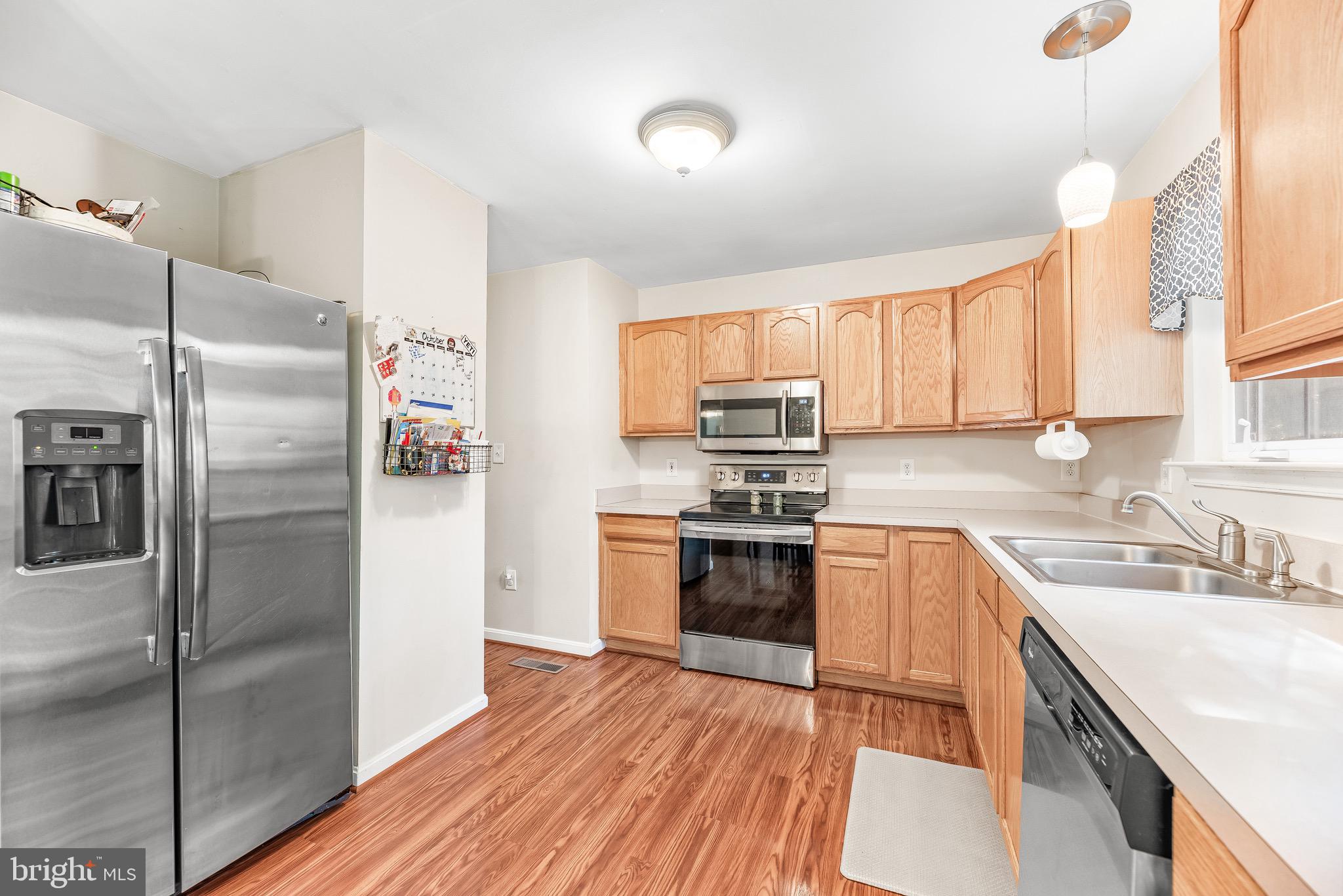11156 Rawhide Road Lusby, MD 20657 - Photo 14 of 33 a kitchen with a refrigerator stove and sink