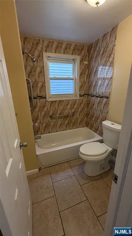 a bathroom with a toilet a sink and bathtub