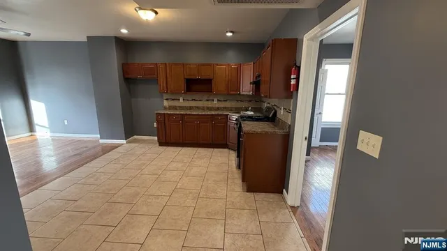 a kitchen with stainless steel appliances granite countertop a refrigerator and a stove