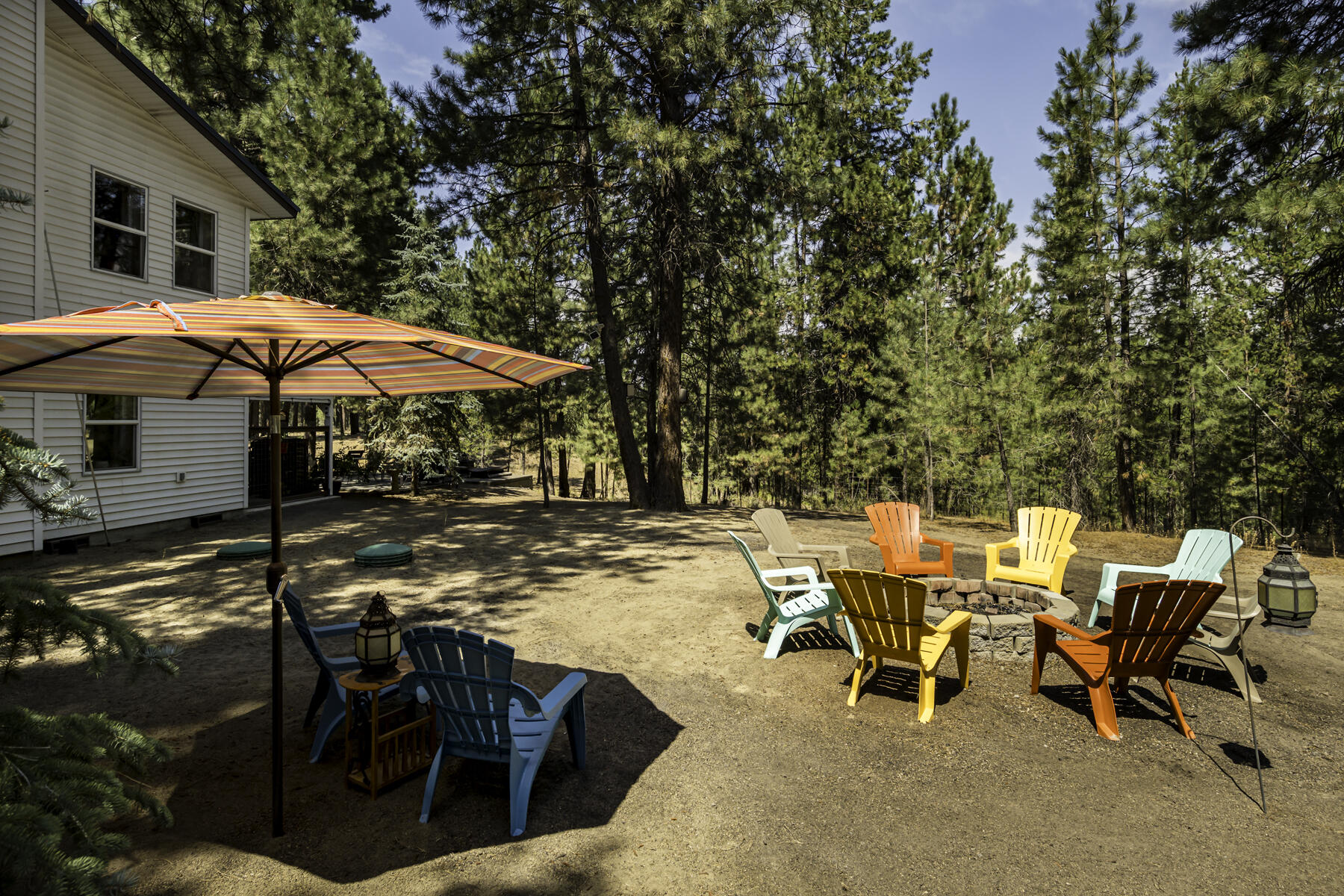 15730 Jackpine Road La Pine, OR 97739 - Photo 38 of 43 a view of a patio with chairs and a table under an umbrella