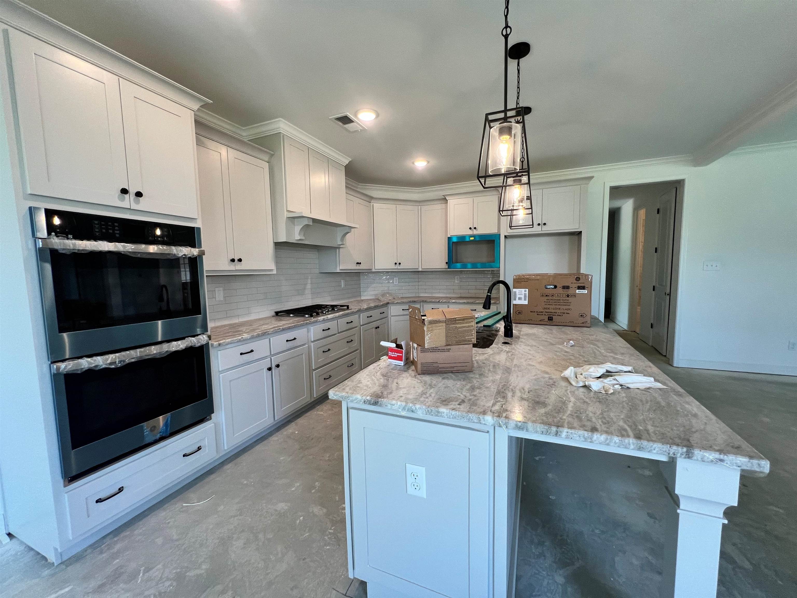 240 Drake Drive Collierville, TN 38017 - Photo 3 of 10 a kitchen with kitchen island granite countertop a stove a sink a oven and a granite counter tops