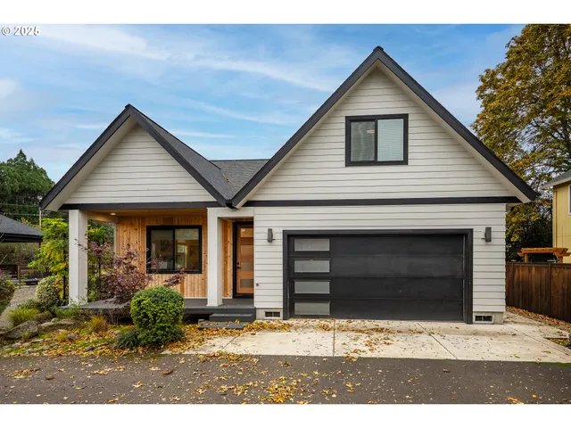 a aerial view of a house with a yard and potted plants