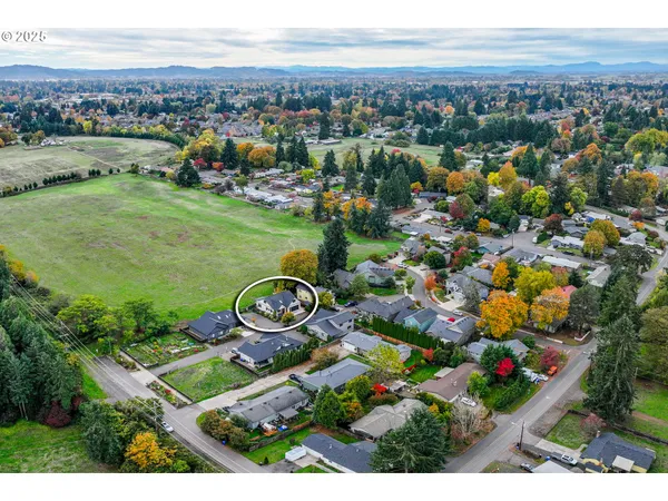 an aerial view of a house with a yard