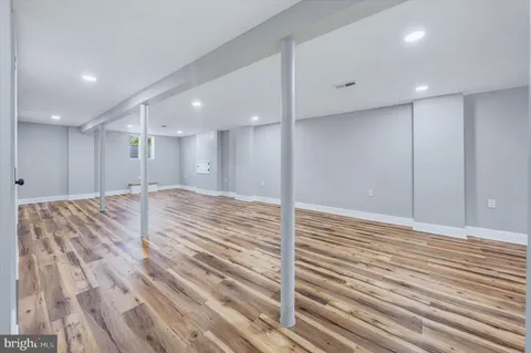 a view of a room with wooden floor