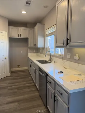 a kitchen with stainless steel appliances a sink stove and cabinets