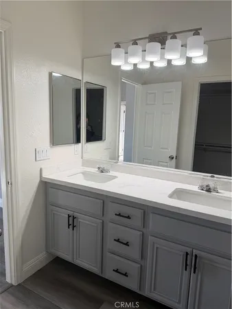 a bathroom with a double vanity sink and a mirror